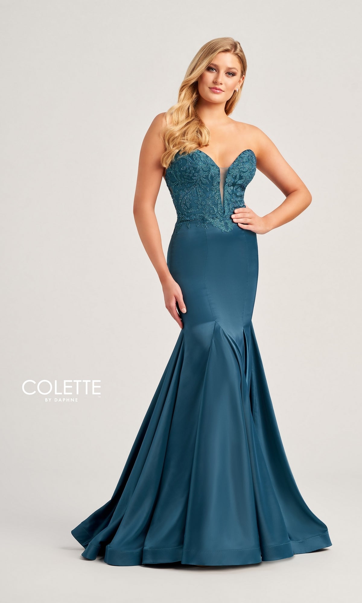A woman stands against a plain light background wearing the Strapless Colette Long Mermaid Prom Dress CL5116, featuring a beaded sweetheart bodice and a smooth satin mermaid skirt.